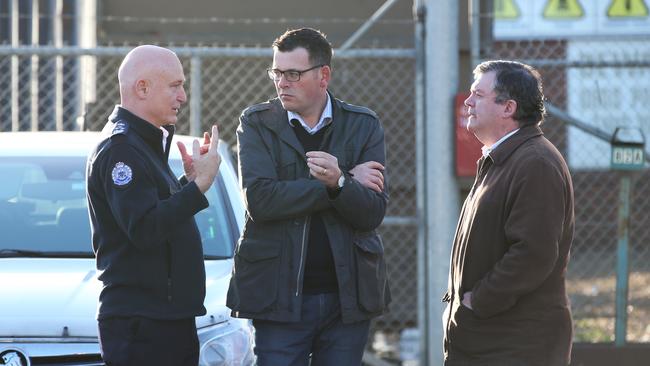 Premier Daniel Andrews is briefed at the Coolaroo recycling factory on Saturday. Picture: David Crosling