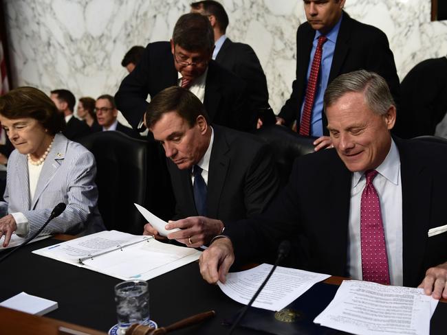 Democrats Senator Dianne Feinstein (L), Democrat Senator Mark Warner (C) and Vice Chairman, Intelligence Committee and Republican Senator Richard Burr (R), Chairman, Intelligence Committee prepare before former FBI Director James Comey. Picture: AFP