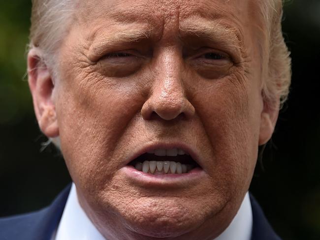 (FILES) In this file photo former US President Donald Trump speaks to the press as he departs the White House in Washington, DC, on August 6, 2020. - Former US president Donald Trump stole the spotlight at a wedding in his Mar-a-Lago resort in Florida over the weekend, using a congratulatory speech to mainly talk about himself and assail his successor. "Do you miss me yet?" a tuxedo-clad Trump asked at the March 27, 2021 function, according to video posted on celebrity gossip site TMZ. His question was met with whoops of delight and applause from guests at the wedding, between longtime Trump friends Megan Noderer and John Arrigo, according to Business Insider. (Photo by Olivier DOULIERY / AFP)