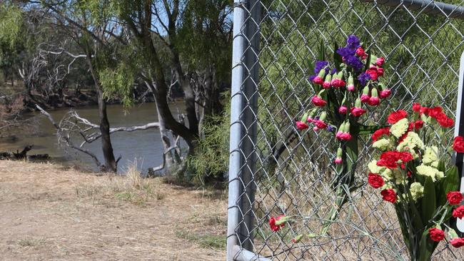 Flowers have been placed on the banks of the Murray River in Moama where the body of a five year old boy was found after his mother allegedly drowned him. Picture: David Crosling