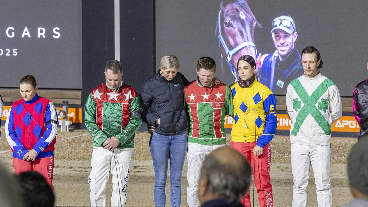 Greg Sugars' partner Jess Tubbs (black jacket) and star international driver James Herbertson (to Jess's left) bow their heads at an emotional tribute to the late star driver. Picture: Stuart McCormick