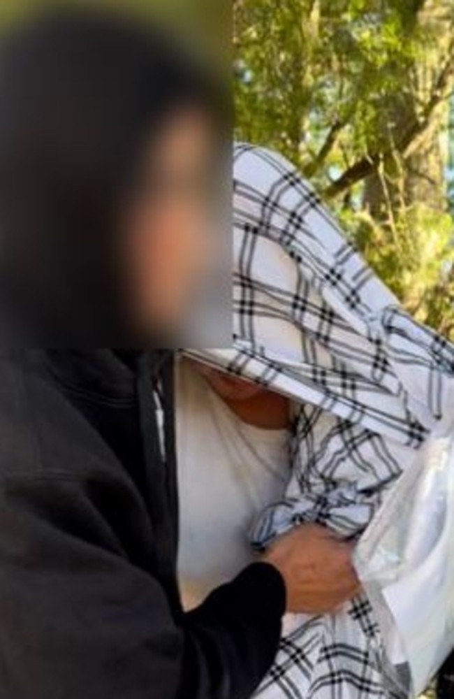Nathan Bernhard leaving Nowra Police Station, hidden under blanket. Picture: Tom McGann