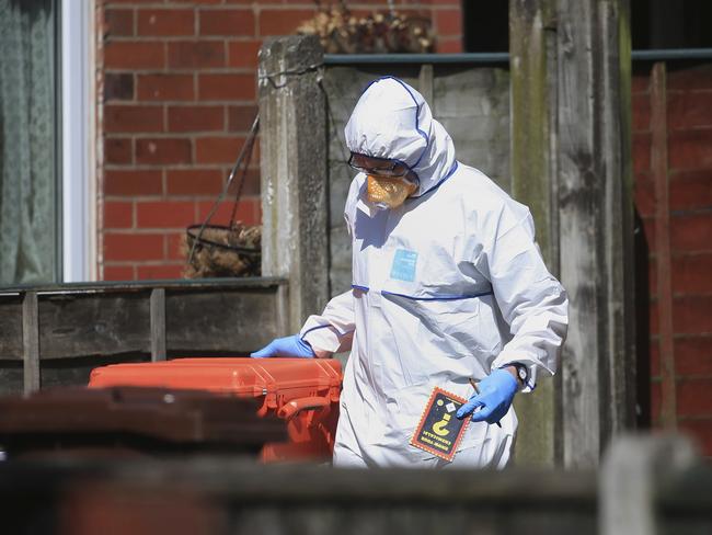 A forensic police officer could be seen leaving the home of the alleged bomber with a “know your chemicals” booklet. Picture: Danny Lawson/PA via AP