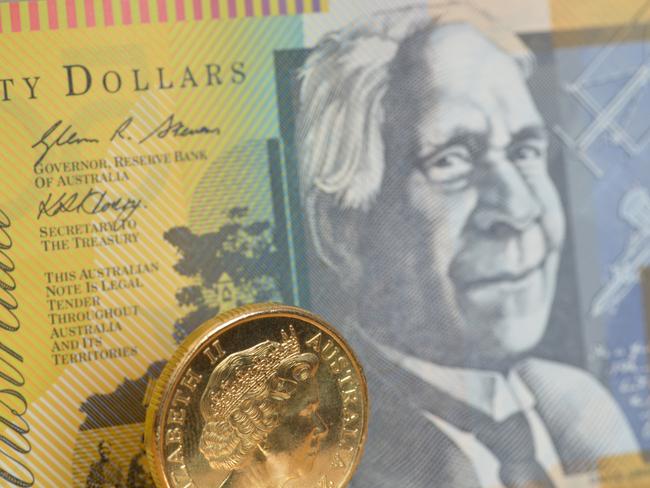 Focus on a one dollar coin with a fifty dollar note behind, Australian money generic notes, cash