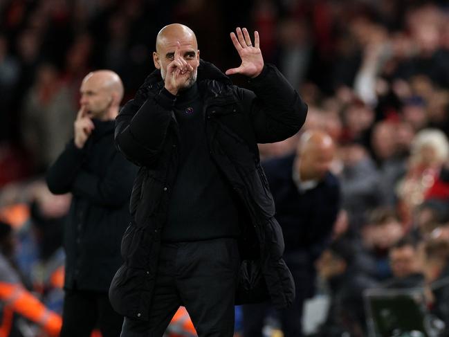 Pep Guardiola reacts to Liverpool fans chanting “you’re getting sacked in the morning”. Picture: AFP