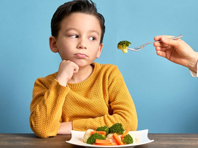 Child is very unhappy with having to eat vegetables. There is a lot of vegetables on his plate. He hates vegetables.