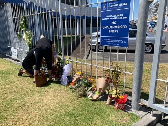 Floral tributes and cards were left near a gate at the Port of Tauranga in NZ where the Ovation of the Seas is presently docked. Picture: Shane Soutter