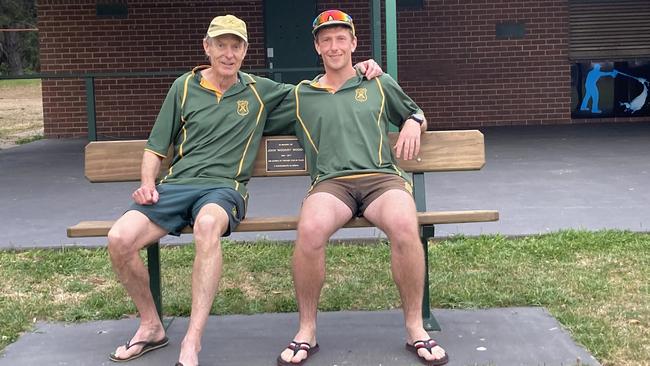 Glen and Jordan Fuhrmann sit on a bench dedicated to Mt Eliza Cricket Club legend, the late John Woods. Picture: Supplied