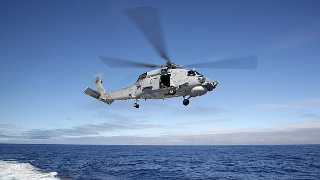 A  Royal Australian Navy Seahawk searches for missing Malaysia Airlines flight MH370.i