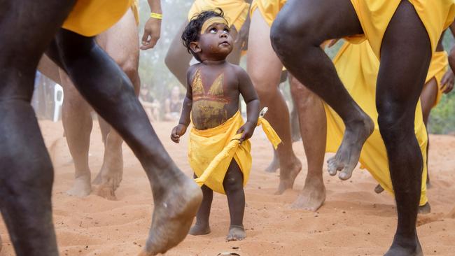 As Australians consider how to vote in a referendum on the Aboriginal and Torres Strait Islander Voice to Parliament, this image from the Garma festival in East Arnhem Land shows a young boy learning traditional dancing from elders. Picture: Melanie Faith Dove.