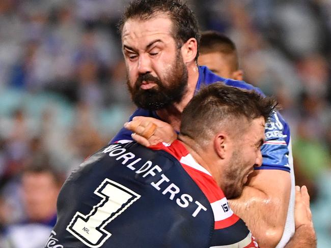 Aaron Woods is tackled by James Tedesco.