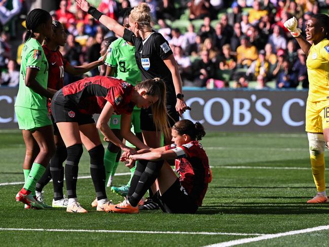 Canada's Christine Sinclair is consoled after having her penalty saved by Nigeria's goalkeeper Chiamaka Nnadozie (right). Picture: WILLIAM WEST / AFP