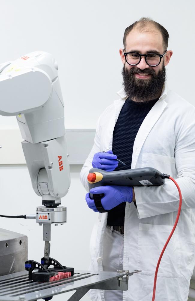 UniSQ Centre for Agricultural Engineering Research Fellow Dr Basem Adel Aly, and the automated robotic arm cutting red meat. Picture: UniSQ