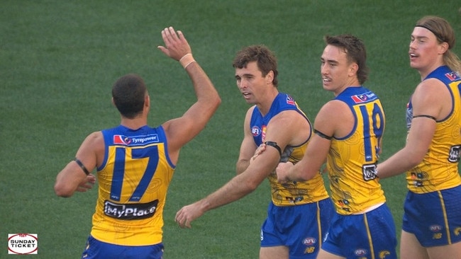 Cripps celebrates his goal by tapping the black armband.