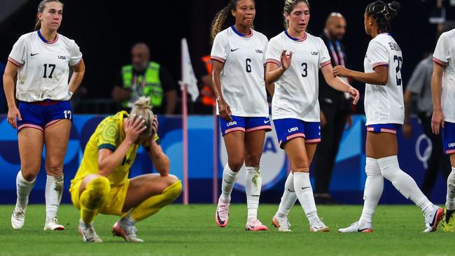 Australia's defender #14 Alanna Kennedy reacts as US' players celebrate at the end of the women's group B football match between Australia and the USA of the Paris 2024 Olympic Games at the Marseille Stadium in Marseille on July 31, 2024. (Photo by Pascal GUYOT / AFP)