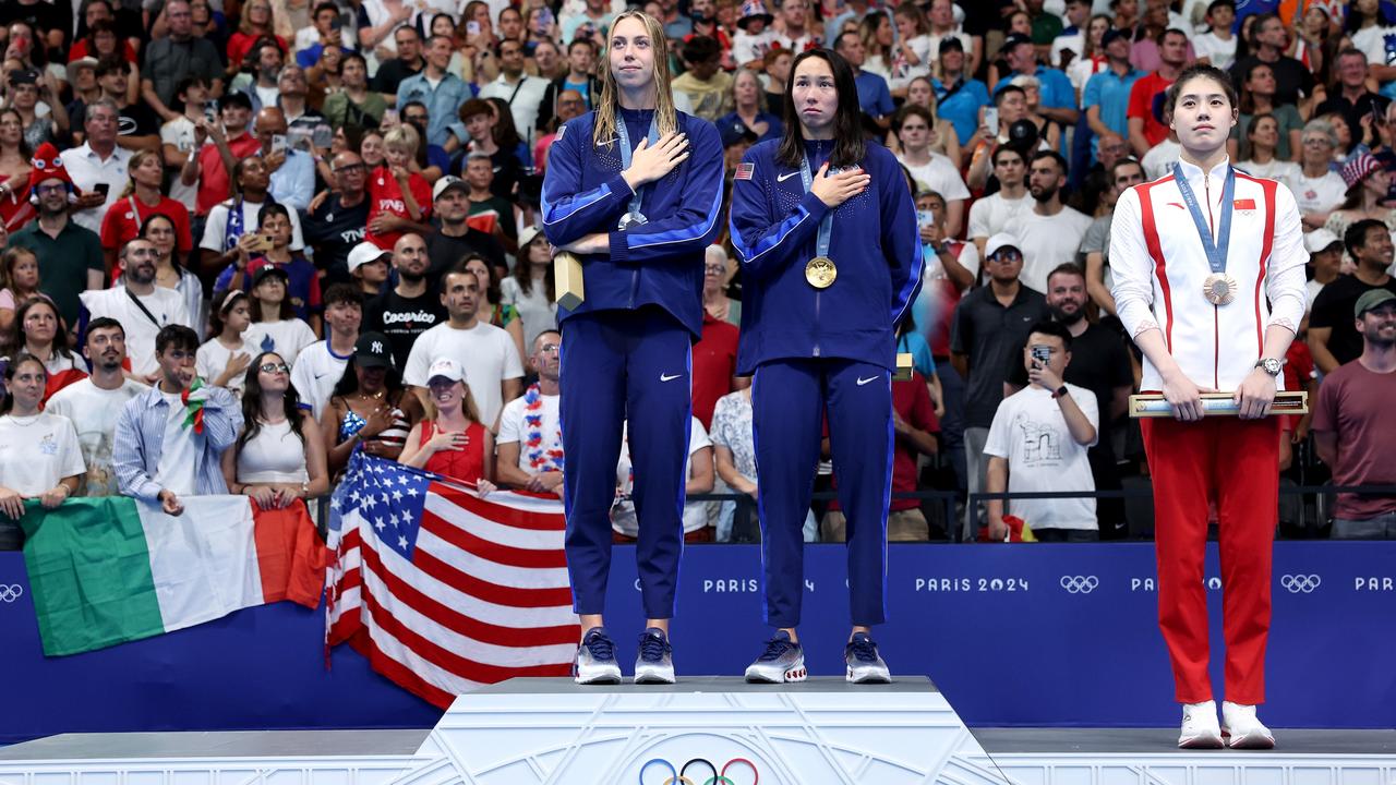 Torrie Huske (centre) shares the top step with Gretchen Walsh. (Photo by Quinn Rooney/Getty Images)