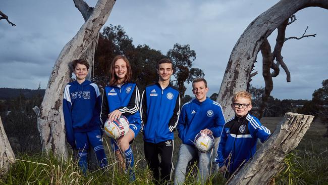 Modbury VIsta Soccer Club’s junior members Luke, Claire, Daniel, Leigh and Jay are happy for the club to be moved to Golden Grove where Tea Tree Gully Council recently bought land. Picture:AAP/Matt Loxton.