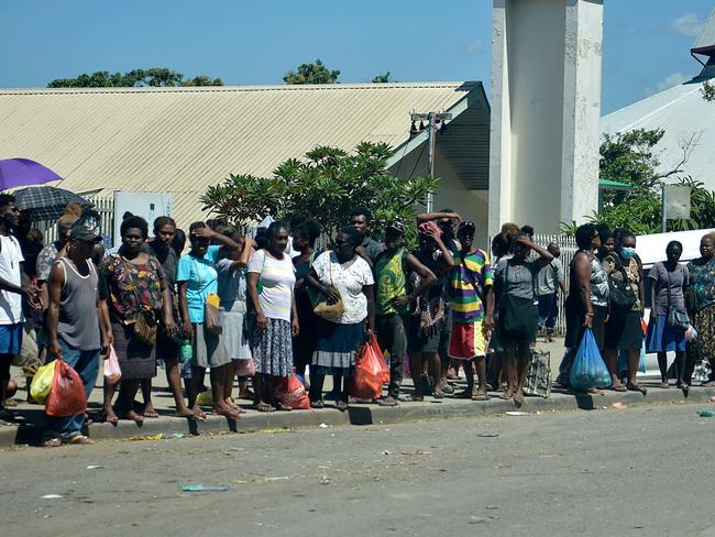 Residents stay in the open in downtown of Honiara after the tremor. Picture: AFP.