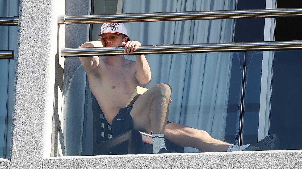 Callum Mills watching his teammates train from his balcony today. Picture: Michael Klein