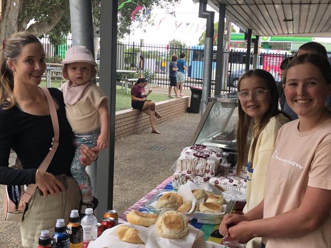 Gemma Somervaile (left) and her daughter Zoey, 1, buying brunch at a fundraising stall at the polling booth in Allambie Heights Public School, staffed by sisters Alice, 12 and Erica Robson, 14. Picture: Jim O'Rourke