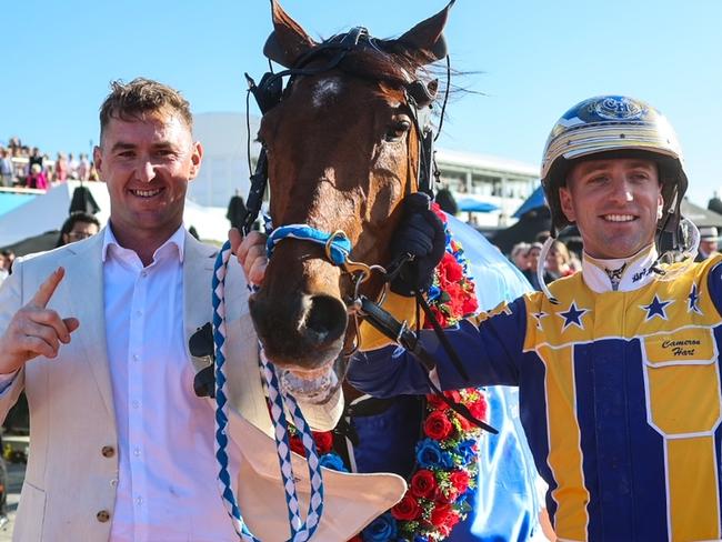 Swayzee's trainer Jason Grimson (left) and driver Cameron Hart celebrate the champ's NZ Cup win. Picture: HRNZ