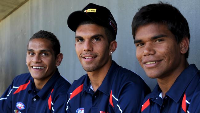 Dom Barry, Crow Curtly Hampton and Jake Neade get together for an AFL Indigenous All-Stars team in 2013.