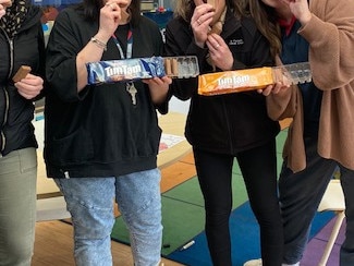 Teachers rip into some Tim Tams. Picture: Supplied