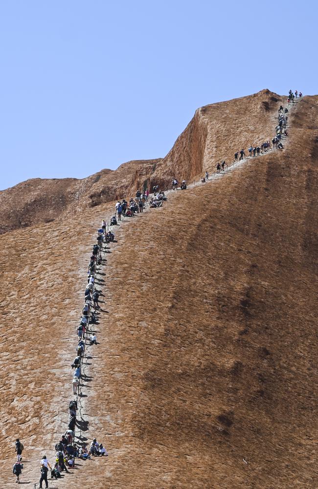 Tourists are seen climbing Uluru, also known as Ayers Rock at Uluru-Kata Tjuta National Park in the Northern Territory on the last day. Picture: AAP