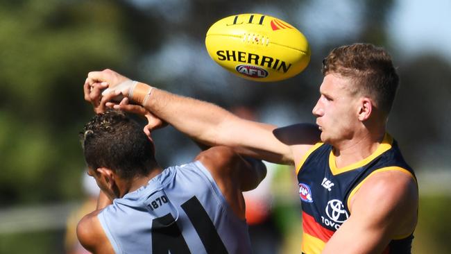 Rory Laird over the top of Dom Barry of Power during the AFL JLT Community Series match between the Port Adelaide Power and the Adelaide Crows at Alberton Oval. Picture: AAP Image/Mark Brake