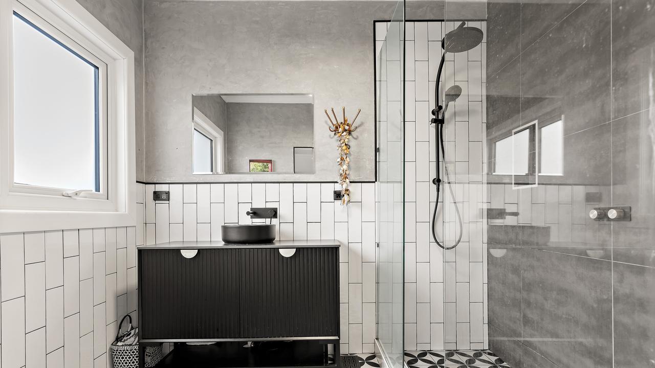 Modern bathroom features a double shower and sleek finishes.