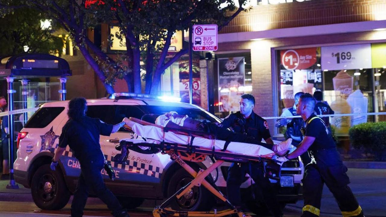 Paramedics transport a person who was wounded by gunfire at the scene where five people were shot near the intersection of East Chicago Avenue and North State Street Thursday, May 19, 2022, in Chicago. (Armando L. Sanchez/Chicago Tribune/Tribune News Service via Getty Images)