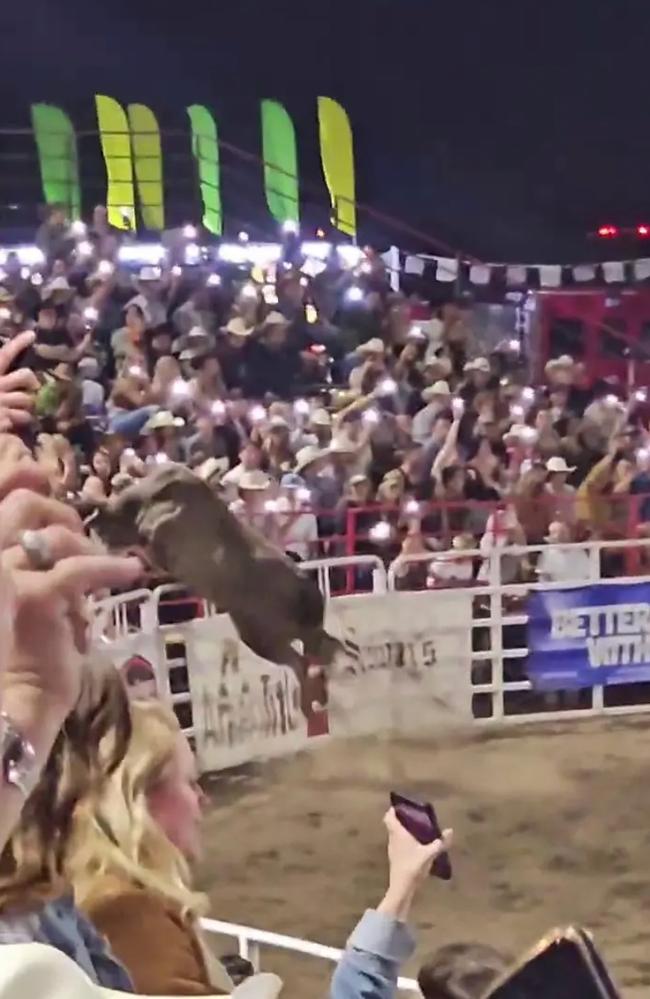 An out-of-control rodeo bull leaped out of an arena and charged through a crowd of spectators Saturday, violently tossing and trampling a woman who was in its path.