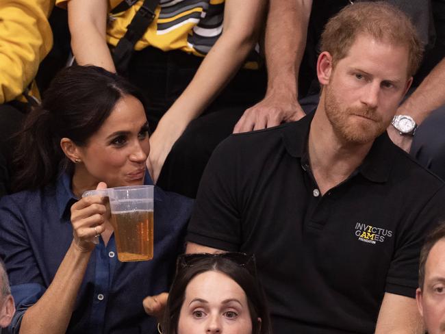 The couple drank beer as they took in the volleyball match on Harry’s birthday. Picture: George Rogers/SIPA/Mega Agency