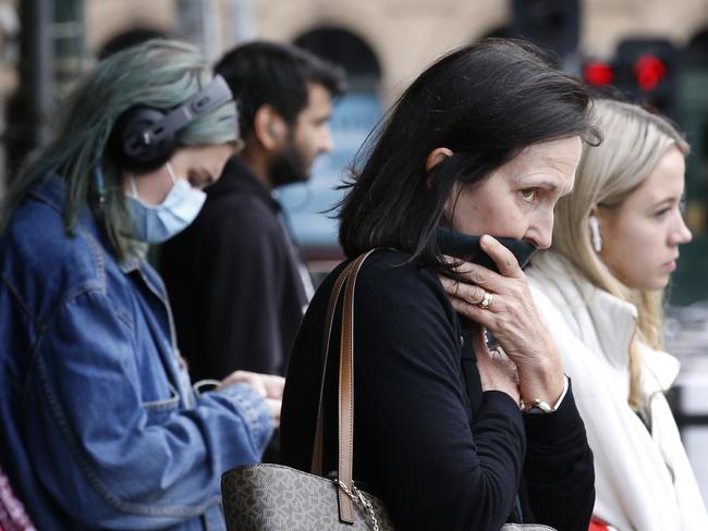 Empty Melbourne city landmarks due to COVID-10 virus shutdown. Outside Flinders Street Station some people wear masks others make do.     Picture: David Caird