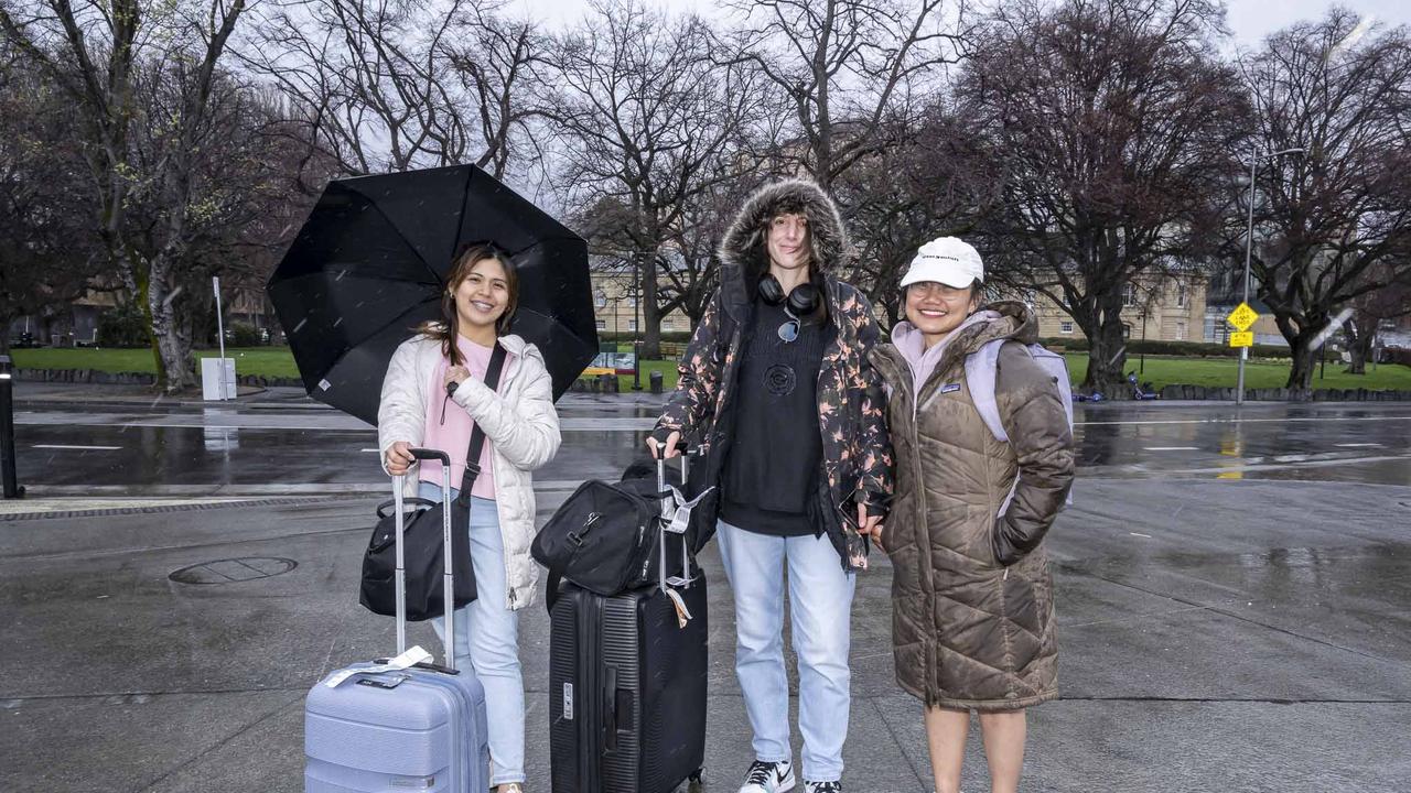 Tasmania Wet Weather - Michelle Gajisan, Jessie Smith and Nikohla Inofinada from Sydney at Salamanca. Picture: Caroline Tan