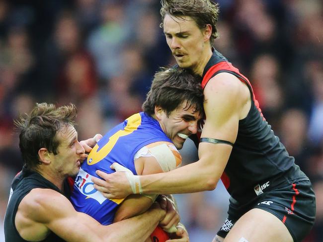 Jobe Watson and Joe Daniher wrap Andrew Gaff in a tackle. Picture: Getty Images