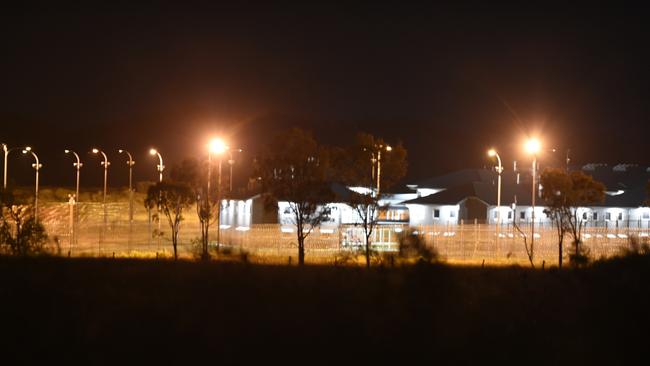 Police vehicles at the perimeter of the Capricornia Correctional Centre during the riots and protests.