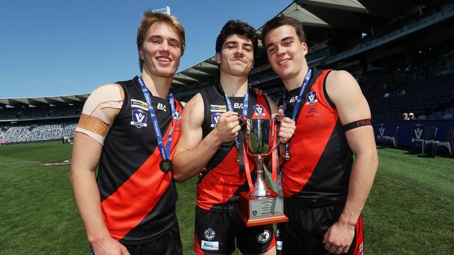 Jack Robinson, Ben Pennisi and Hugh Ross with the U18 premiership cup after Newtown &amp; Chilwell’s win over St Josephs. Picture: Alan Barber