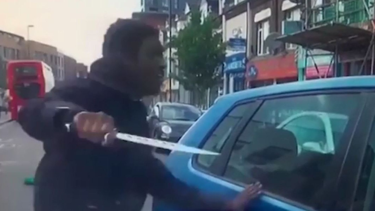 A cyclist is pictured wielding a knife during a road rage incident in London.