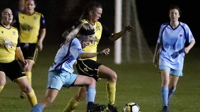 Jenna Mortimer and Siobhan Macken fight for possession in the FNQ Premier League women's match between the JCU Strikers and the Edge Hill Tigers, held at JCU Oval, Smithfield. PICTURE: BRENDAN RADKE