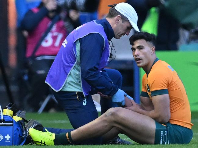 Australia's centre Joseph-Aukuso Suaalii is treated by medical staff after being hurt in a collision with Scotland's centre Sione Tuipulotu (not pictured) during the Autumn Nations Series International rugby union test match between Scotland and Australia at Murrayfield Stadium in Edinburgh on November 24, 2024. (Photo by ANDY BUCHANAN / AFP)