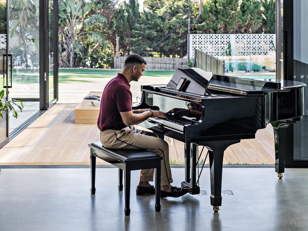 Sebastian playing a baby grand piano at his luxurious Maroubra mansion. Picture: Instagram