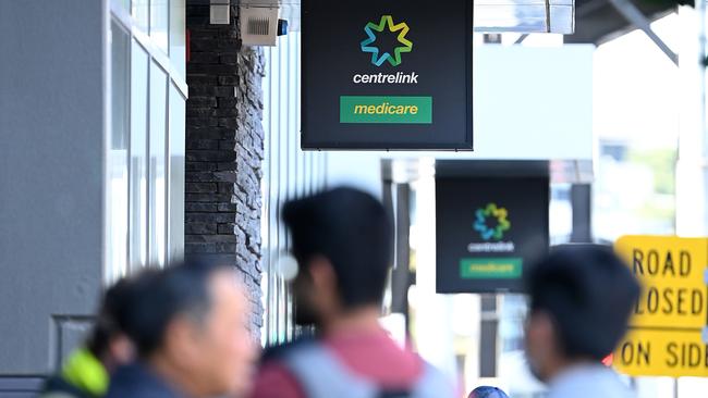 MELBOURNE, AUSTRALIA - MARCH 24: Peopler queue to enter Centrelink on March 24, 2020 in Melbourne, Australia. Non-essential travel has been banned in a bid to stop the spread of COVID-19 in Australia while venues such as bars, clubs, nightclubs, cinemas, gyms and restaurants, along with anywhere people remain static are now closed. Schools are currently open but parents have the option to keep children at home if they wish. There are now 1887 confirmed cases of COVID-19 in Australia and the death toll now stands at eight. (Photo by Quinn Rooney/Getty Images)