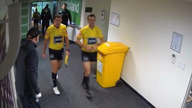 The match officials walk past without confrontation.