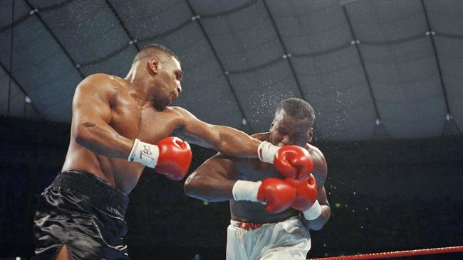 Mike Tyson (L) fighting against US challenger James Douglas (R) in the seventh round of their world heavyweight boxing title bout more than 30 years ago. (Photo by Junji KUROKAWA / AFP)