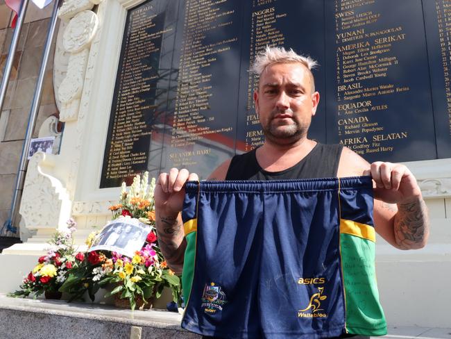 Australian Joshua Maurer visits the memorial in Legian, Kuta during the 17th commemoration and put a pair of shorts with the name of his six friends who were killed. Picture. Lukman S. Bintoro