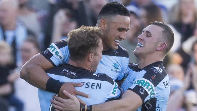 Valentine Holmes celebrates a try with his Sharks teammates.