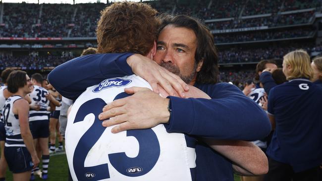 MELBOURNE, AUSTRALIA - SEPTEMBER 24: Cats head coach Chris Scott hugs Gary Rohan of the Cats after winning the 2022 AFL Grand Final match between the Geelong Cats and the Sydney Swans at the Melbourne Cricket Ground on September 24, 2022 in Melbourne, Australia. (Photo by Daniel Pockett/AFL Photos/via Getty Images)