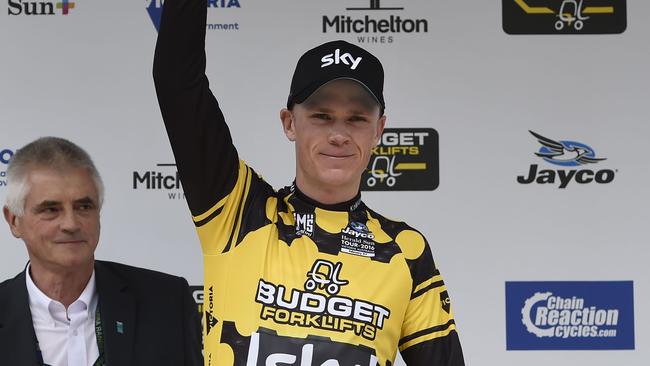 Britain's cyclist Christopher Froome (R) of Team Sky waves while wearing the King of the Mountain jersey on the podium after stage one of the 2016 Herald Sun Tour cycling race, Healesville to Healesville, in Victoria on February 4, 2016. AFP PHOTO / MAL FAIRCLOUGH -- IMAGE STRICTLY RESTRICTED TO EDITORIAL USE - STRICTLY NO COMMERCIAL USE --