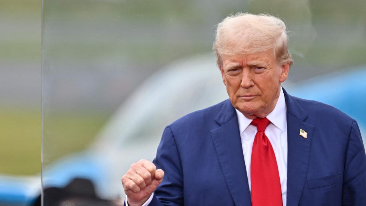 Former US President Donald Trump gestures to the crowd as he stands behind bulletproof glass. Picture: by Peter Zay / AFP